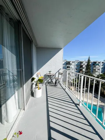 a view of a balcony with chairs