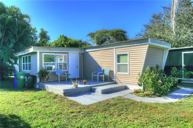 a view of a house with backyard porch and sitting area