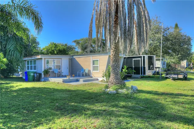 a view of a chair and table in backyard of the house