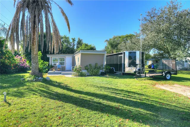 a view of a chair and table in backyard of the house