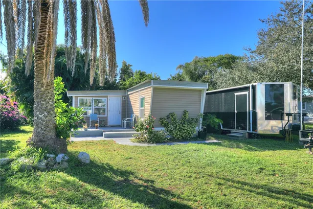a backyard of a house with table and chairs