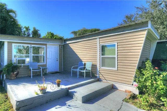 a living room with furniture and large windows