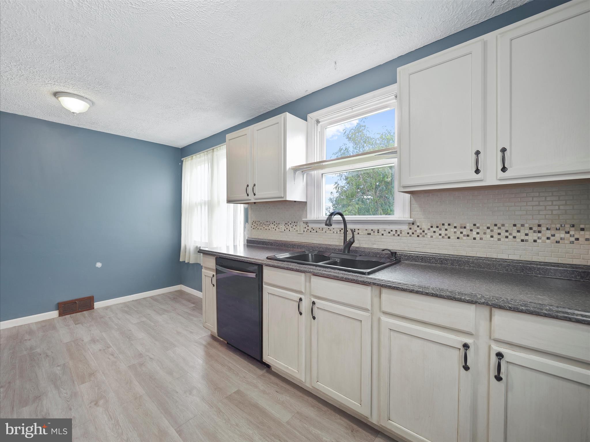224 Devonshire Road Hagerstown, MD 21740 - Photo 12 of 28 a kitchen with granite countertop white cabinets and a sink