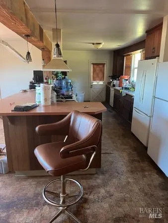 a kitchen with a sink and a refrigerator