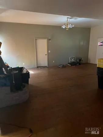 a living room with furniture pool table and a mirror