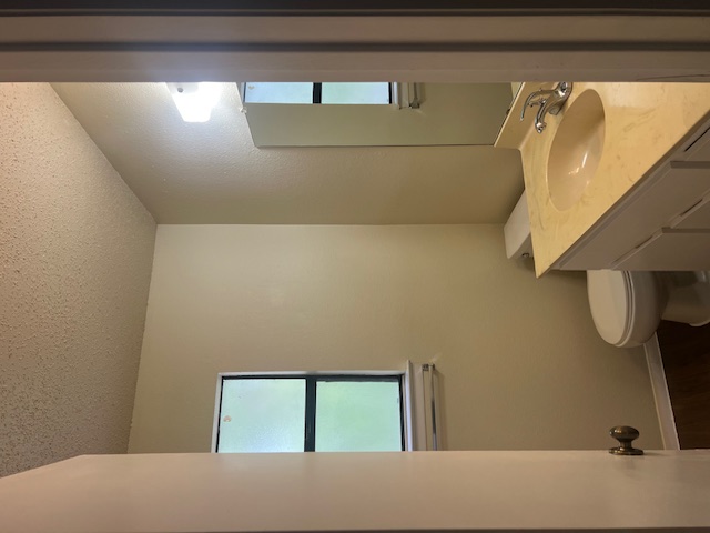11429 Ptarmigan Drive, Unit B Austin, TX 78758 - Photo 16 of 27 a bathroom with a sink toilet and vanity