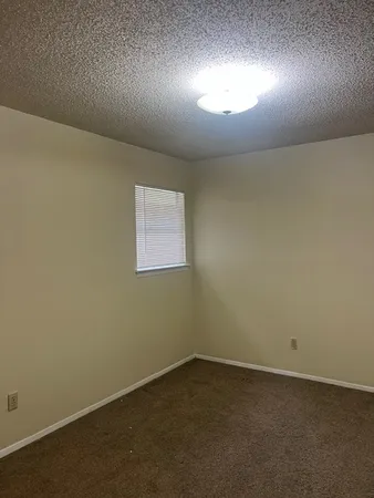 an empty room with a empty space and windows