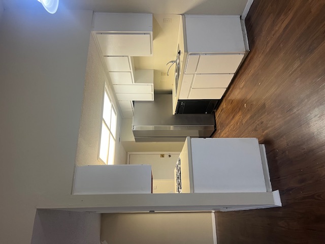 11429 Ptarmigan Drive, Unit B Austin, TX 78758 - Photo 2 of 27 a large kitchen with a lot of counter space and wooden floor