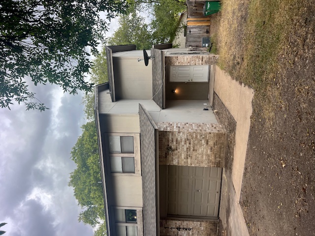 11429 Ptarmigan Drive, Unit B Austin, TX 78758 - Photo 25 of 27 a front view of a house with a yard and garage