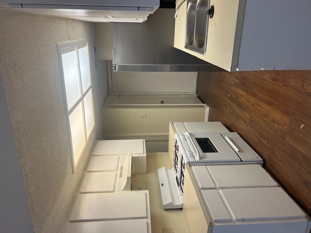 11429 Ptarmigan Drive, Unit B Austin, TX 78758 - Photo 3 of 27 a kitchen with a stove sink and cabinets
