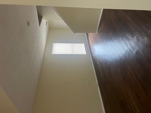 11429 Ptarmigan Drive, Unit B Austin, TX 78758 - Photo 5 of 27 an empty room with wooden floor and windows
