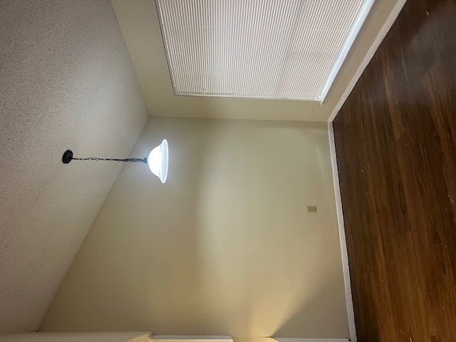 11429 Ptarmigan Drive, Unit B Austin, TX 78758 - Photo 6 of 27 a view of an empty room with wooden floor and a window