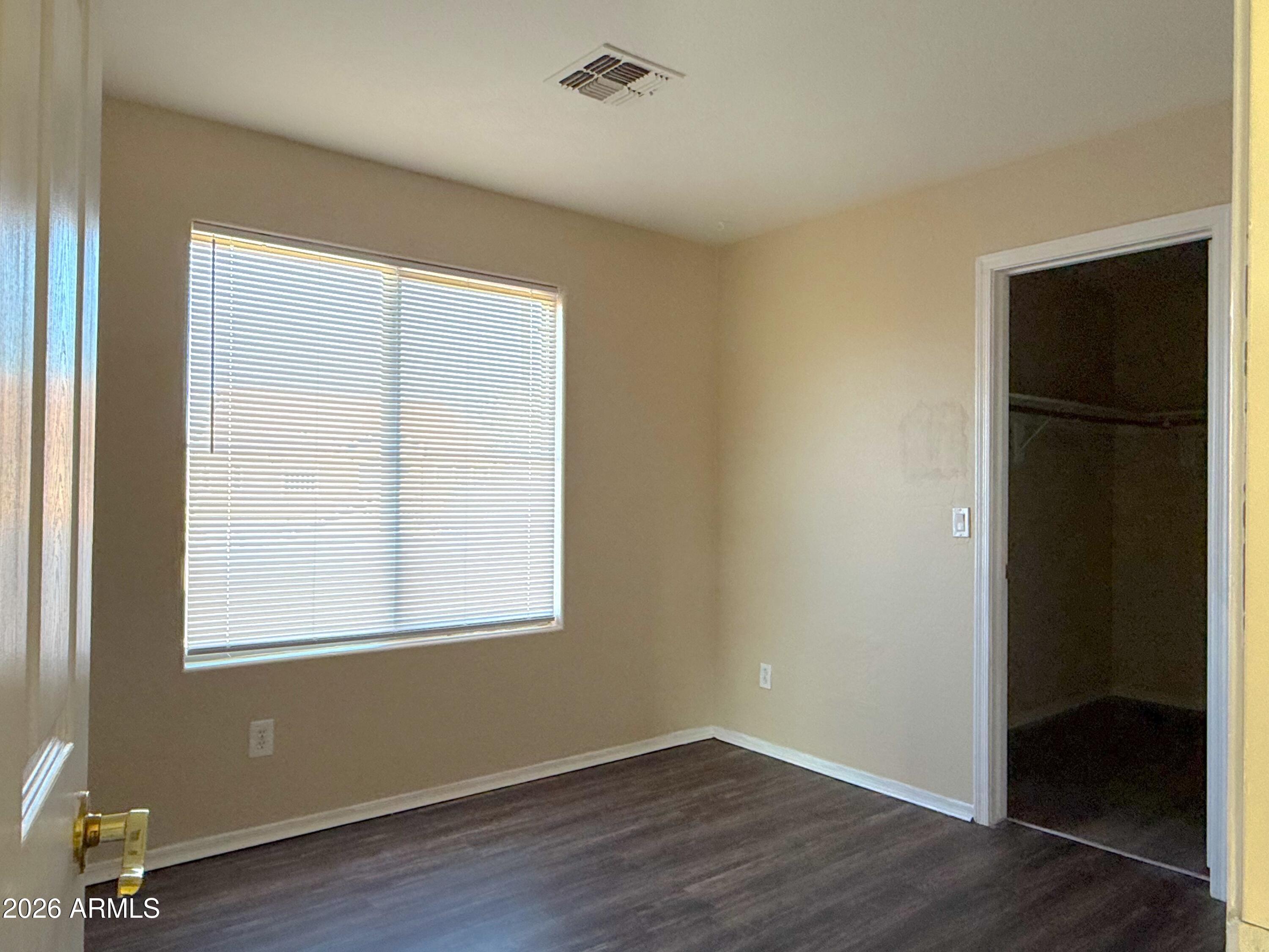 3545 East Crescent Way Gilbert, AZ 85298 - Photo 12 of 19 an empty room with wooden floor and a window