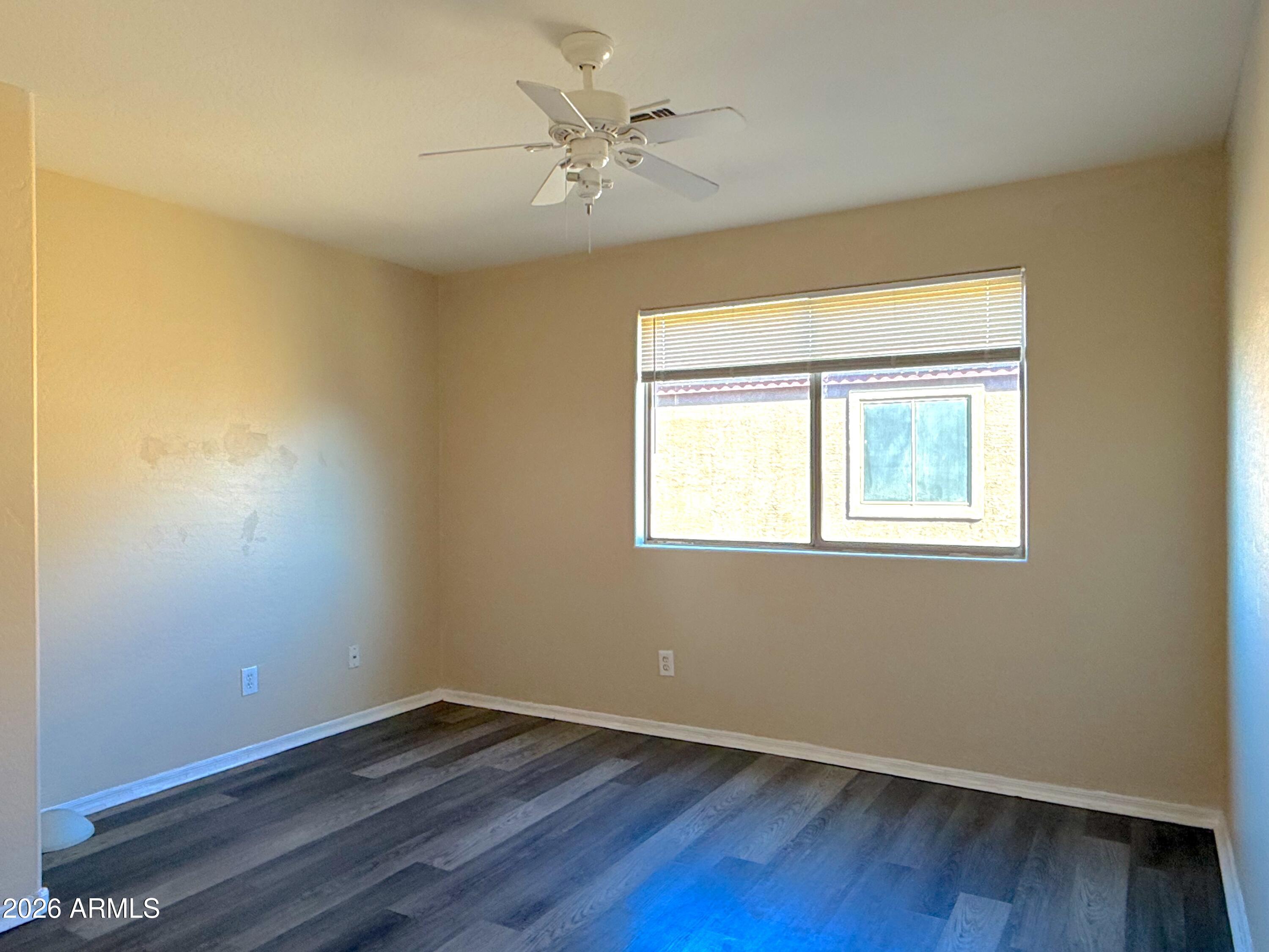 3545 East Crescent Way Gilbert, AZ 85298 - Photo 13 of 19 a view of an empty room with wooden floor and a window