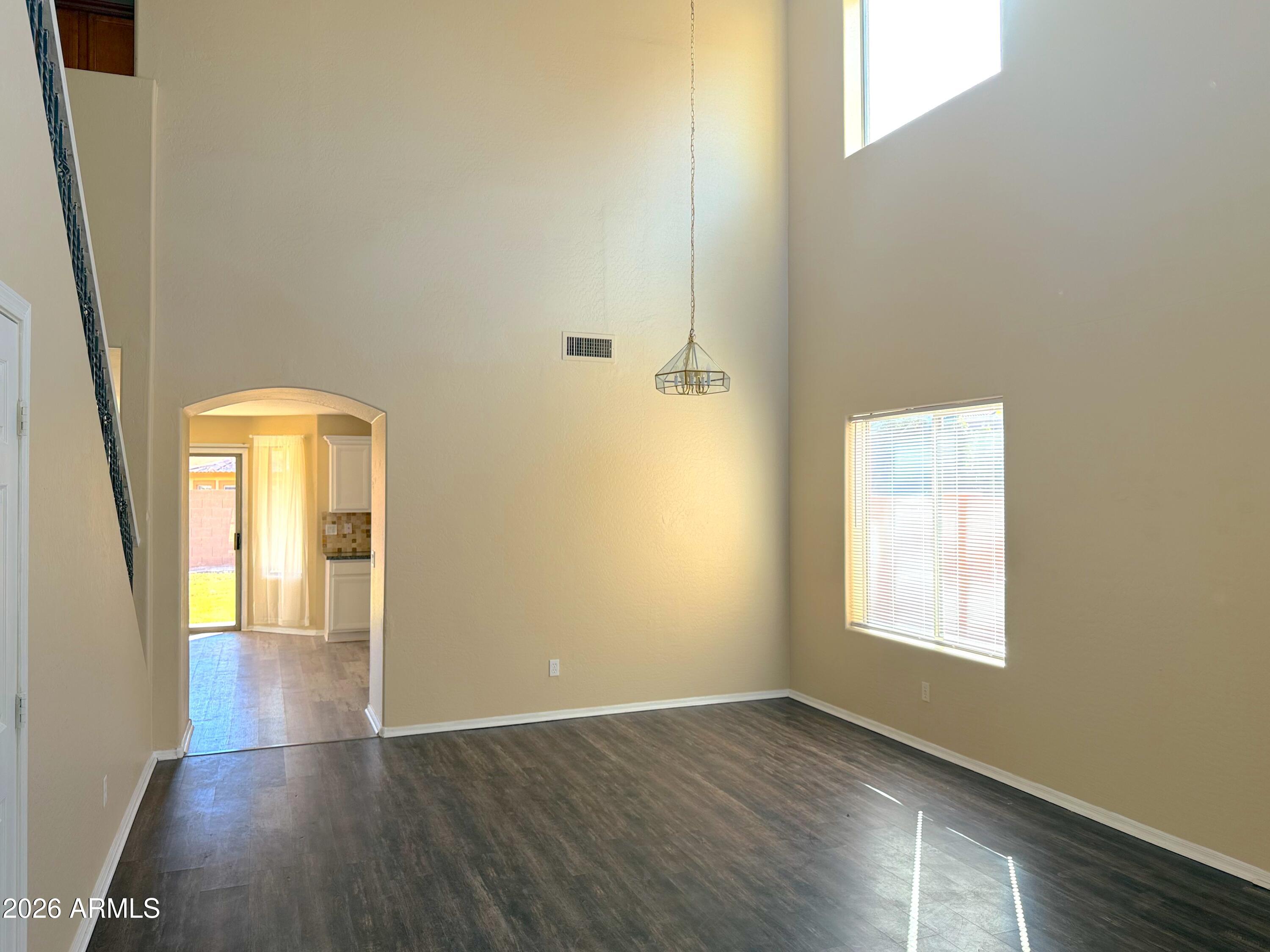 3545 East Crescent Way Gilbert, AZ 85298 - Photo 3 of 19 an empty room with wooden floor and windows