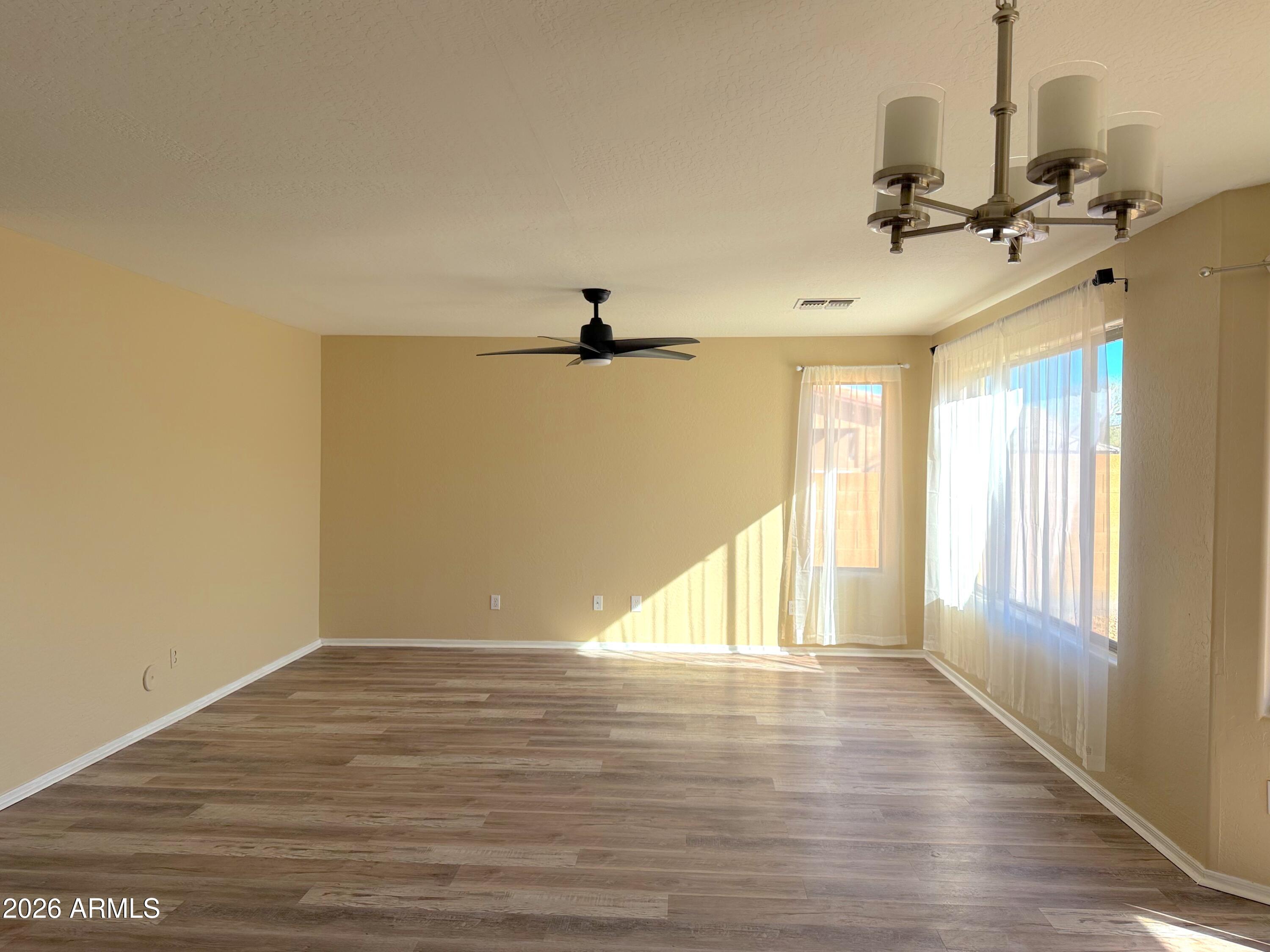 3545 East Crescent Way Gilbert, AZ 85298 - Photo 5 of 19 wooden floor in an empty room with a window