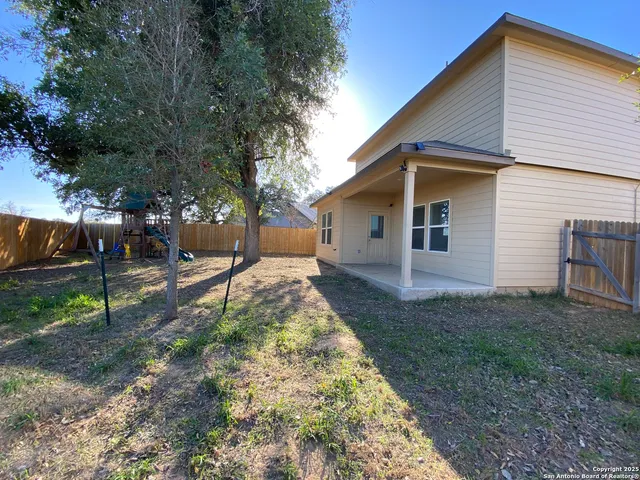 a view of a backyard with table and chairs and a fire pit