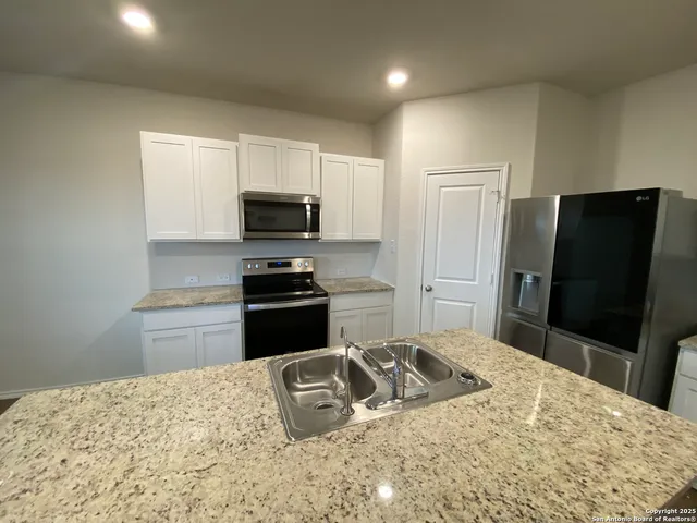 a kitchen with a refrigerator stove and microwave