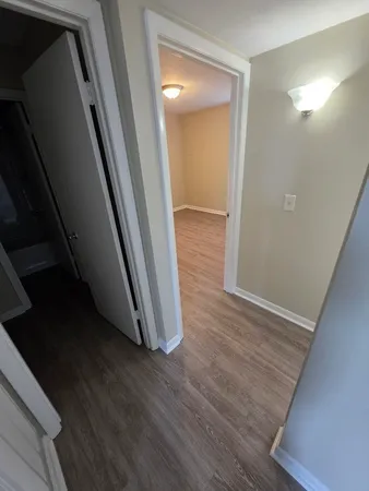 a view of a hallway with wooden floor