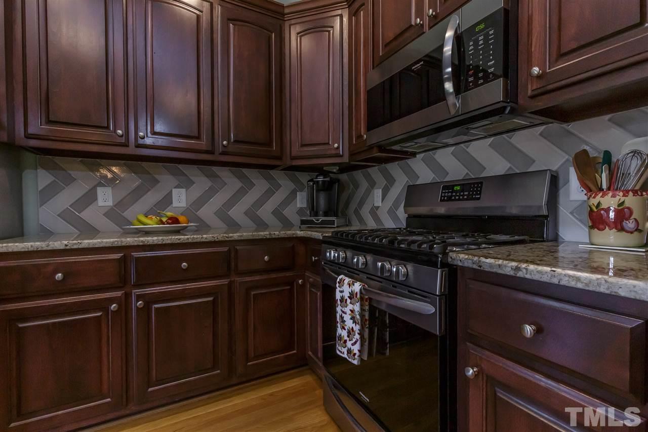 319 Boone Road Burlington, NC 27217 - Photo 9 of 30 Tile back splash, granite counters and warm wood cabinetry