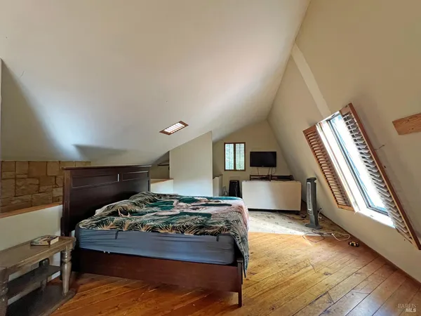 a bedroom with a bed and a large window