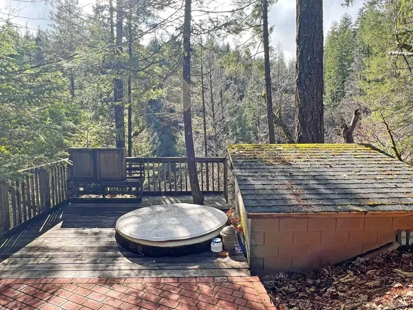 a view of a roof deck with wooden fence and a couple of chairs