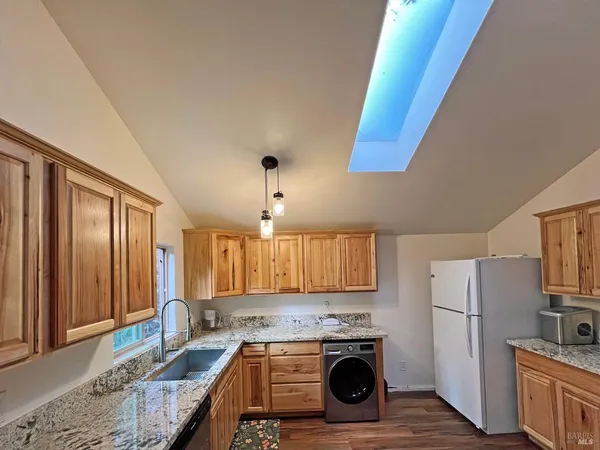 a kitchen with a stove a sink and a refrigerator