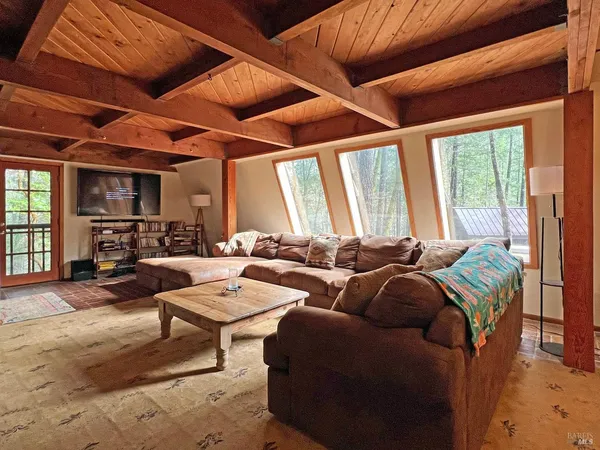 a living room with furniture a table and chairs