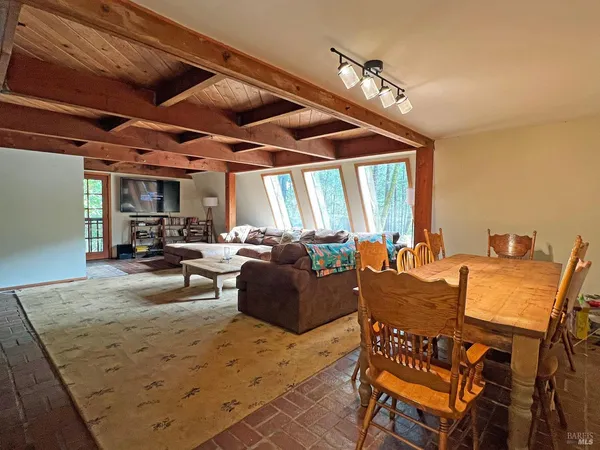 a living room with furniture a window and a table