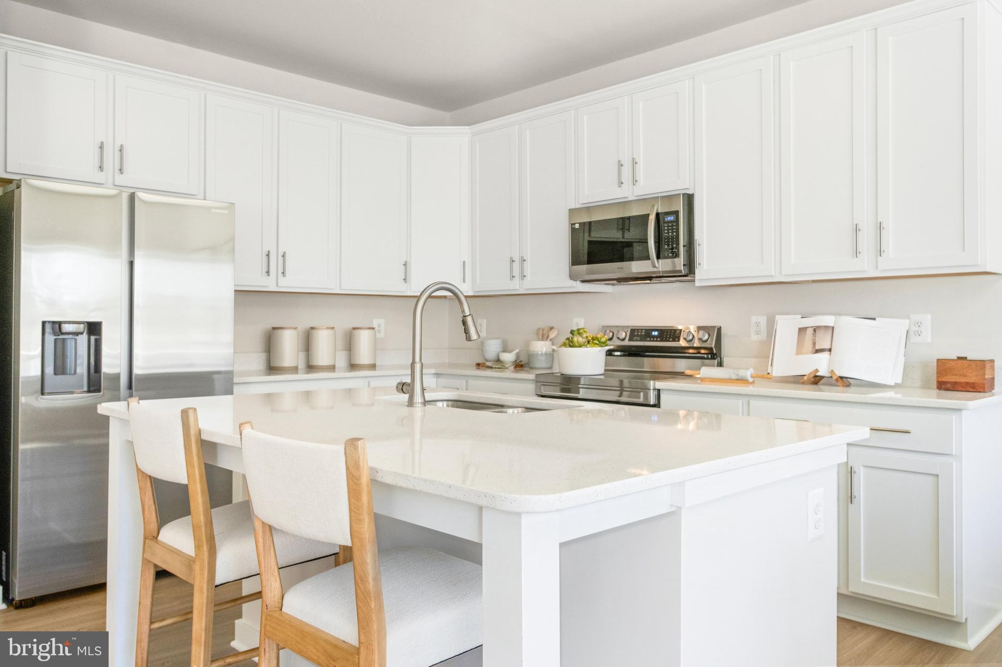 206 Williamson Road Winchester, VA 22602 - Photo 7 of 22 a kitchen with stainless steel appliances granite countertop a stove a sink dishwasher and white cabinets with wooden floor