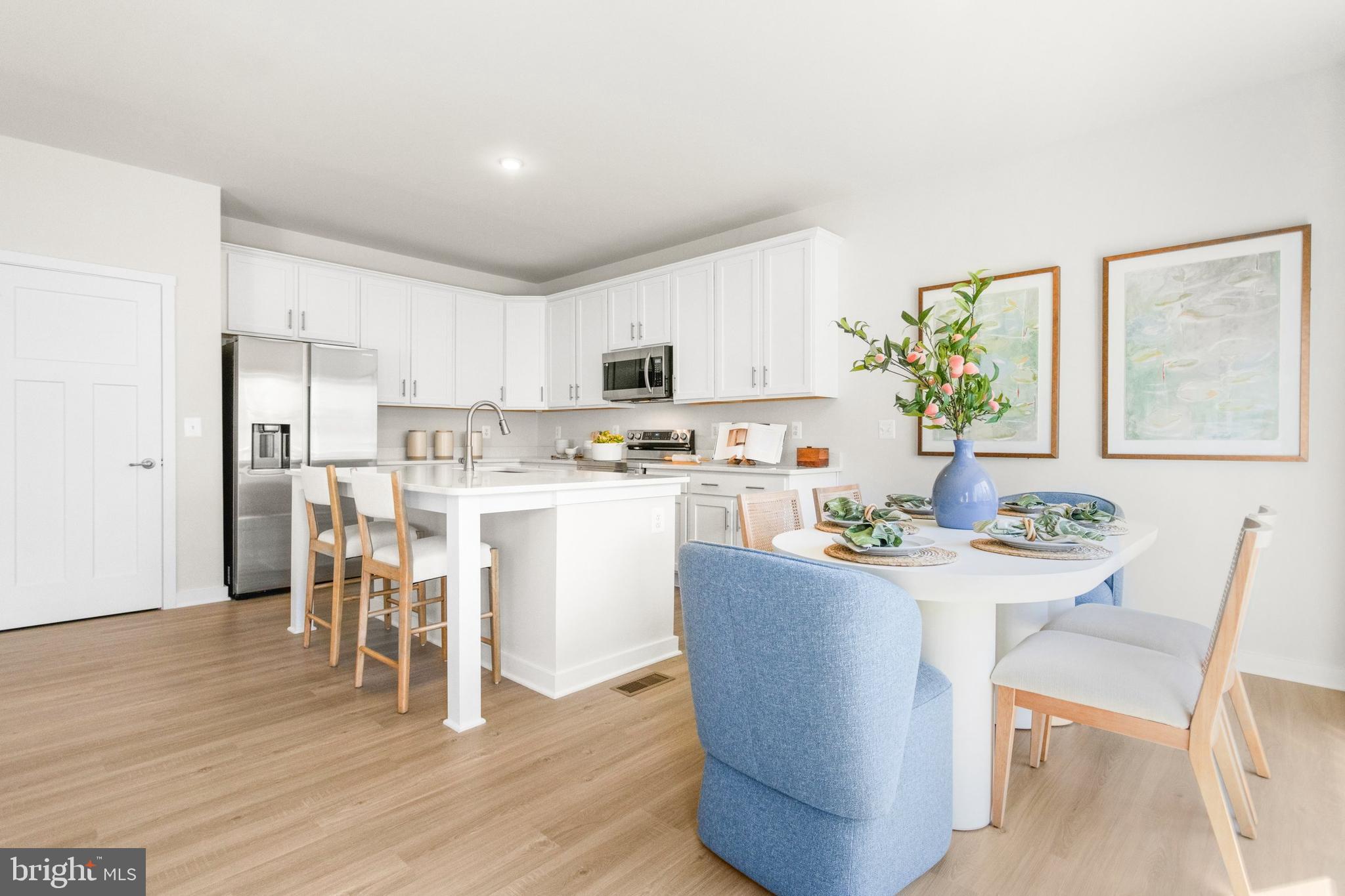 206 Williamson Road Winchester, VA 22602 - Photo 8 of 22 a dining room with stainless steel appliances a dining table wooden floor and a kitchen view
