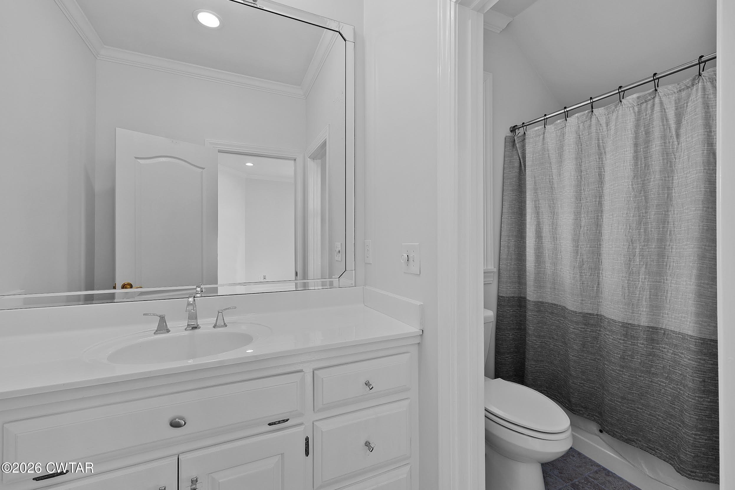 58 Huntington Place Jackson, TN 38305 - Photo 33 of 38 a bathroom with a granite countertop sink a toilet and a mirror