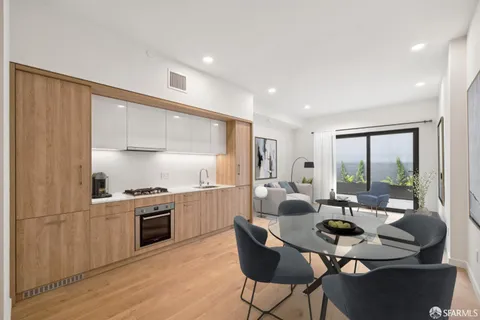 a open kitchen with stainless steel appliances granite countertop a stove a sink dishwasher and a refrigerator with wooden floor