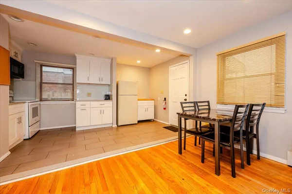 a kitchen with white cabinets and white appliances
