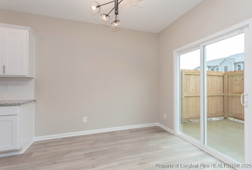 905 Kingscote Drive Fayetteville, NC 28314 - Photo 11 of 30 an empty room with wooden floor closet and windows