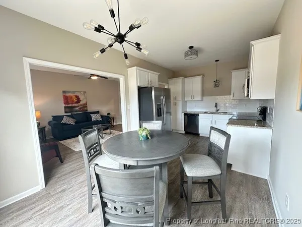a dining room with furniture and window