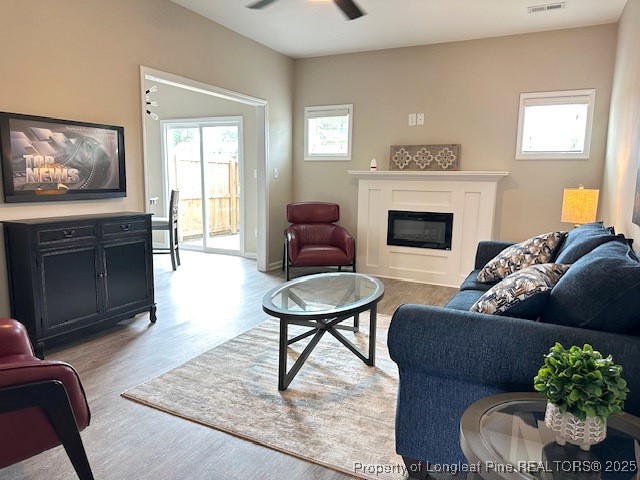 905 Kingscote Drive Fayetteville, NC 28314 - Photo 5 of 30 a living room with furniture a fireplace and a flat screen tv