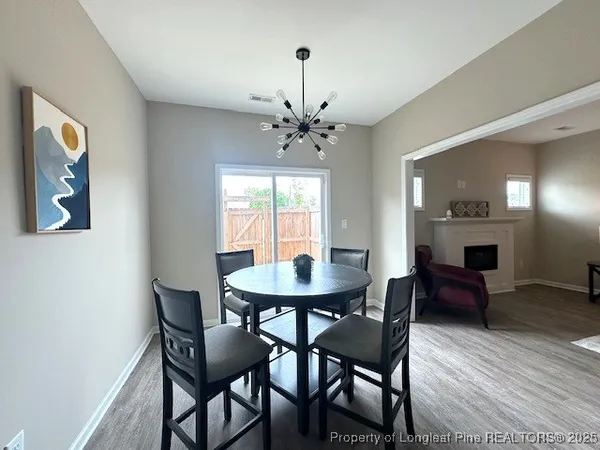 a dining room with furniture and window