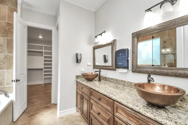 a bathroom with sinks granite countertop a sink and a mirror