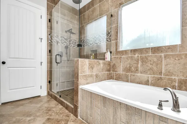 a bathroom with a bathtub and shower