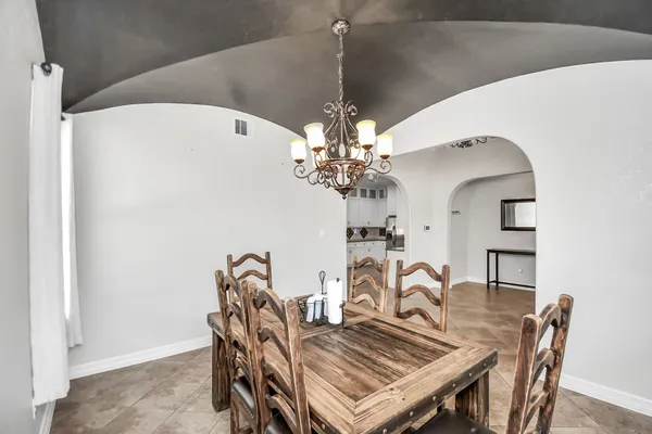 a view of a dining room with furniture and chandelier