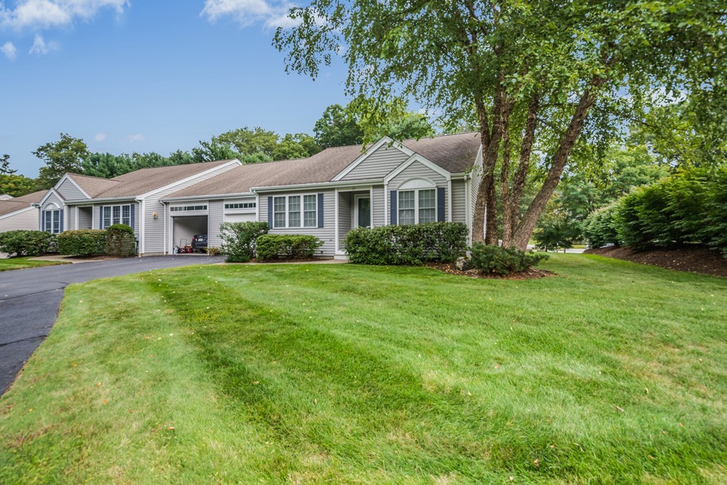 89 Stow Road, Unit 1 Boxborough, MA 01719 - Photo 1 of 25 a front view of a house with a garden