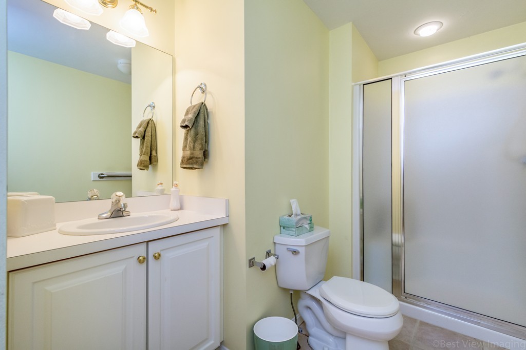 89 Stow Road, Unit 1 Boxborough, MA 01719 - Photo 15 of 25 a bathroom with a granite countertop sink toilet and shower