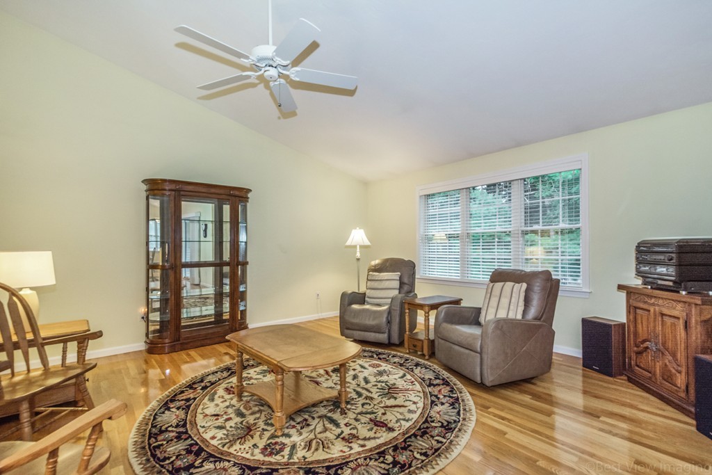 89 Stow Road, Unit 1 Boxborough, MA 01719 - Photo 4 of 25 a living room with furniture and a floor to ceiling window