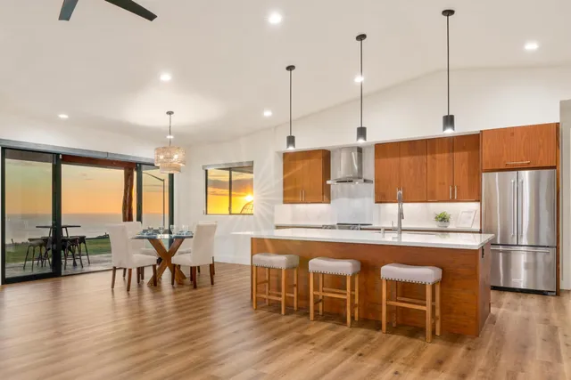a large kitchen with a table and chairs