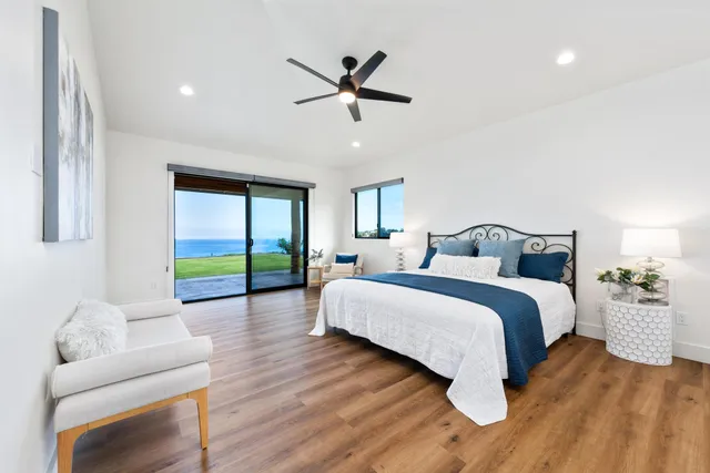 a bedroom with a large bed and a chandelier