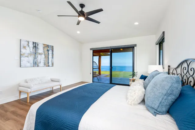 a large white kitchen with a sink and a mirror