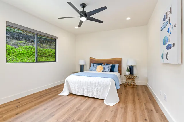 a bathroom with a granite countertop sink a toilet and shower