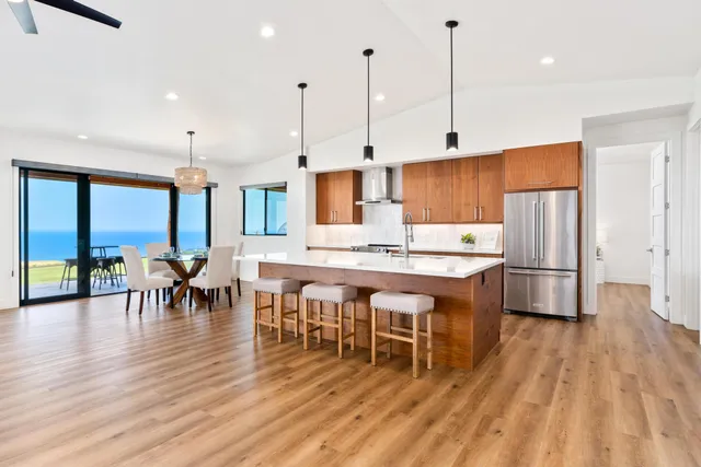 a large kitchen with a table and chairs