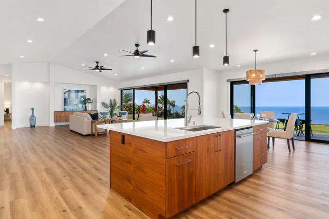 a large kitchen with lots of counter space and wooden floor